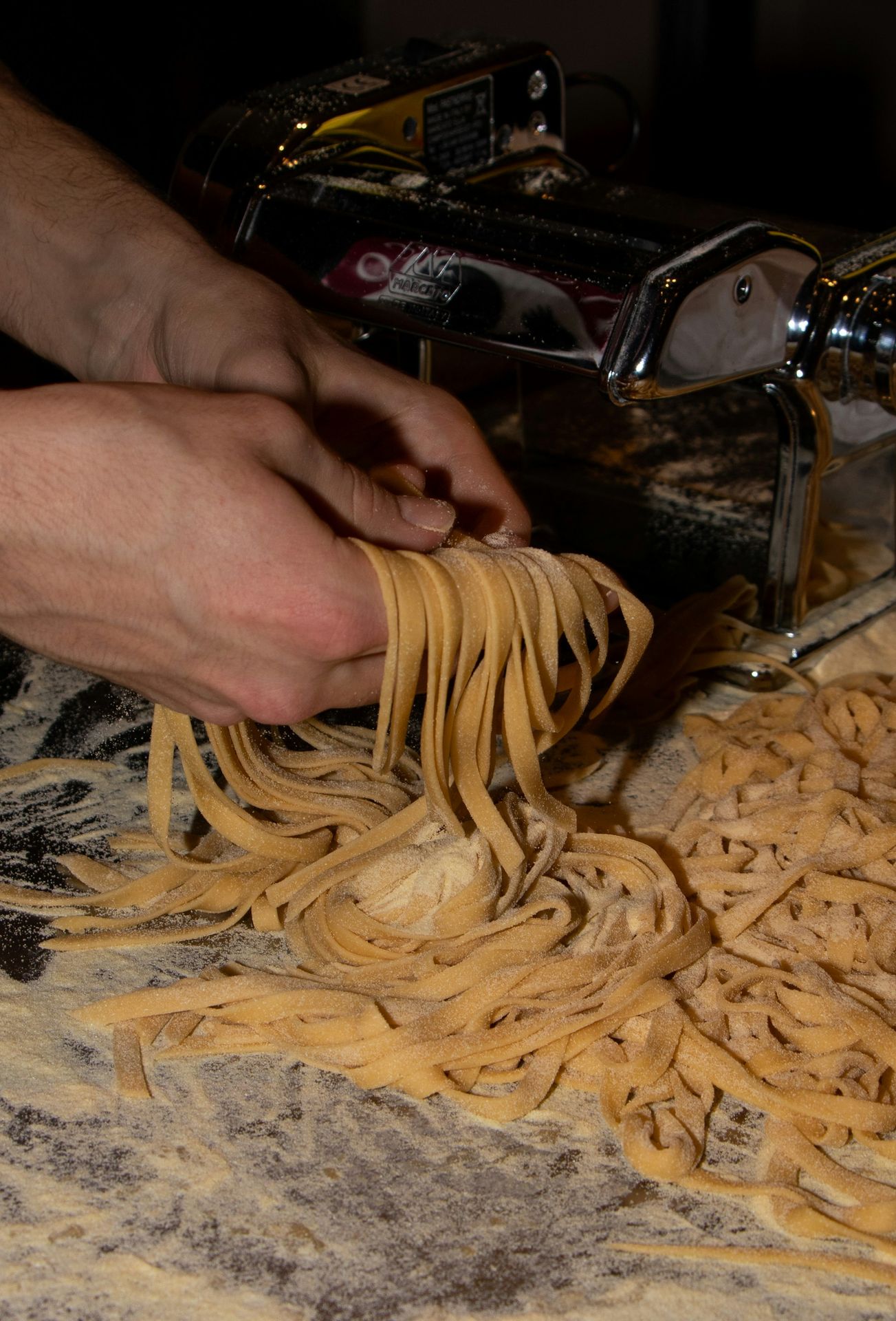 a person is using a pasta machine to make pasta